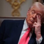 Trump looking angry and bored while sitting in his office