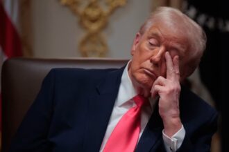 Trump looking angry and bored while sitting in his office