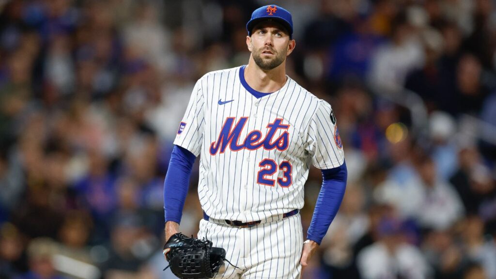 The well-known pitcher drying his hands on his pants as he prepares to deliver his pitch