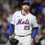 The well-known pitcher drying his hands on his pants as he prepares to deliver his pitch