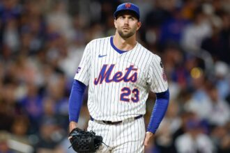 The well-known pitcher drying his hands on his pants as he prepares to deliver his pitch