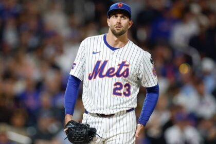 The well-known pitcher drying his hands on his pants as he prepares to deliver his pitch