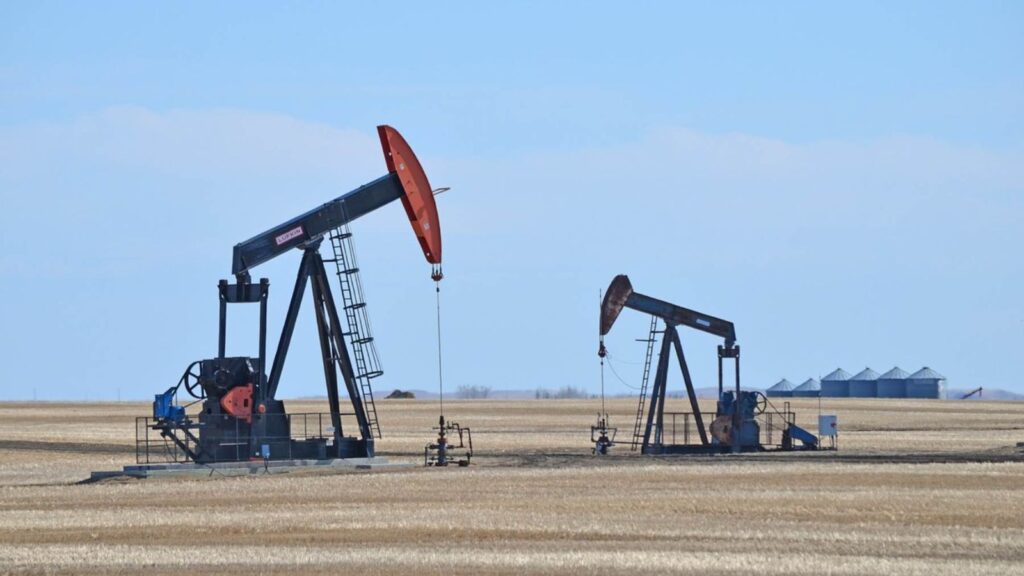 United States - Iran agreement sends oil prices tumbling and boosts global markets A panoramic view of two oil drilling rigs with a beautiful background