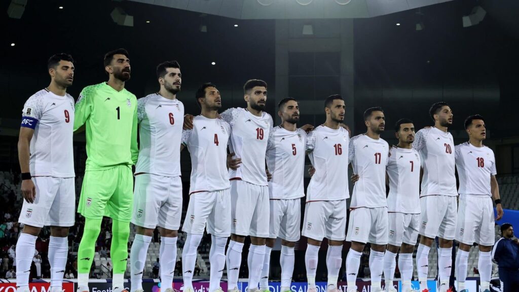 The Iranian national team players embracing each other while singing their country's national anthem