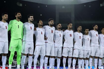 The Iranian national team players embracing each other while singing their country's national anthem
