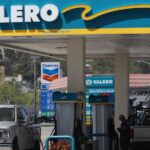 A Valero Energy gas station supplying fuel to several vehicles