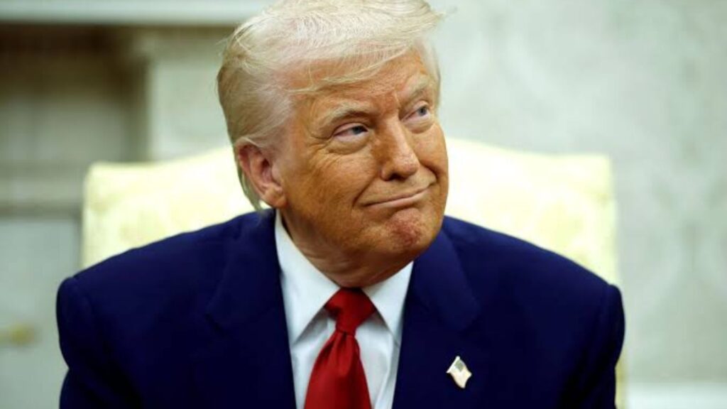 Donald Trump smiling sarcastically while looking to the side at one of his aides