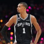 The French superstar standing with his hands on his hips, radiating pride after defeating the Knicks