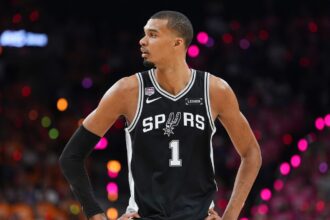 The French superstar standing with his hands on his hips, radiating pride after defeating the Knicks