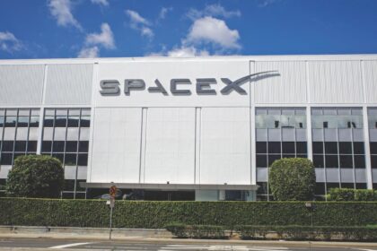 One of SpaceX's white office buildings with its name prominently displayed on the front