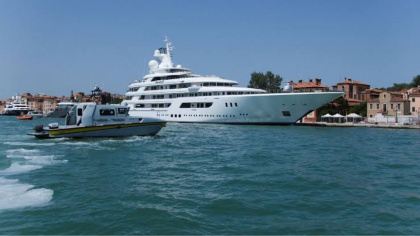 A diplomatic cruise sparks protests in Italy during United States celebrations A luxurious white yacht docked at a small harbor in the city of Venice, Italy