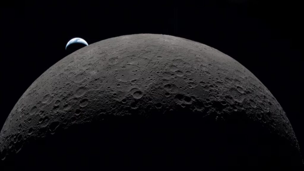 A view from the Moon showing planet Earth rising behind the lunar surface