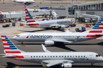 Several American Airlines aircraft parked at an airport awaiting further instructions