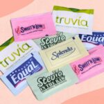 Artificial sweeteners under scrutiny: Study reveals their unexpected impact on gut health Several packets of artificial sweeteners neatly arranged for a photo shoot