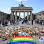 Attack at Berlin pride festival shocks germany and reignites security debate Several LGBTQ+ Pride participants surrounded by flowers and flags placed at the site of the attack in honor of the victims