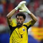 The veteran goalkeeper applauding with his arms raised after achieving a remarkable feat with his national team