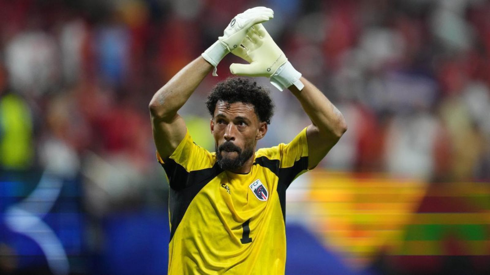 The veteran goalkeeper applauding with his arms raised after achieving a remarkable feat with his national team