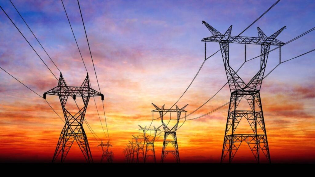 Several power transmission towers in Cuba with a beautiful sunset in the background