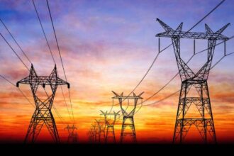 Several power transmission towers in Cuba with a beautiful sunset in the background