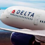The front of a white airplane with the word 'Delta' on one of its sides