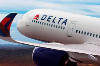 The front of a white airplane with the word 'Delta' on one of its sides
