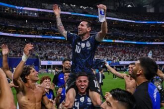Lionel Messi being carried by his teammates after securing a dramatic victory