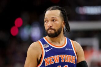 Brunson looking toward the fans during a game while wearing the New York Knicks' blue and orange uniform