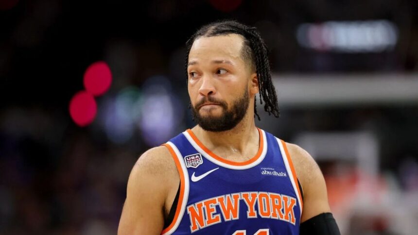 Brunson looking toward the fans during a game while wearing the New York Knicks' blue and orange uniform