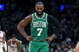 Jaylen Brown with his hands on his hips and a sad expression after being defeated by his current team, the Philadelphia 76ers