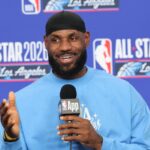 The now-free agent sitting at a press conference, looking very happy and smiling.