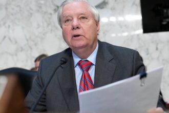 The prominent and well-known U.S. senator standing in the Senate, speaking into a microphone as his colleagues look on