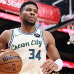 The Greek Freak holding a basketball with one hand
