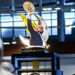 Nearly one million investors lose billions after betting on Trump's cryptocurrency A cardboard cutout of Trump holding a Bitcoin coin high in the air
