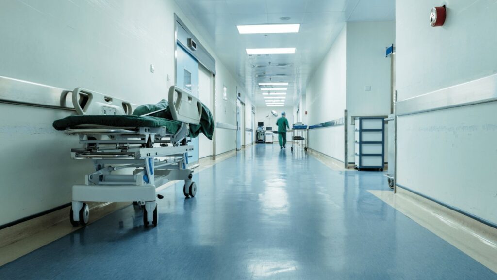 A hallway in a New York hospital with a stretcher positioned along one side