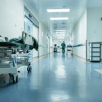 A hallway in a New York hospital with a stretcher positioned along one side