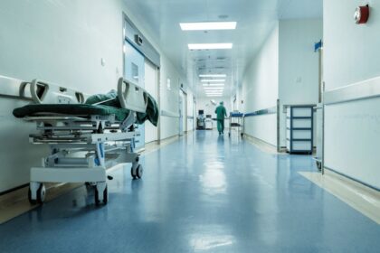 A hallway in a New York hospital with a stretcher positioned along one side
