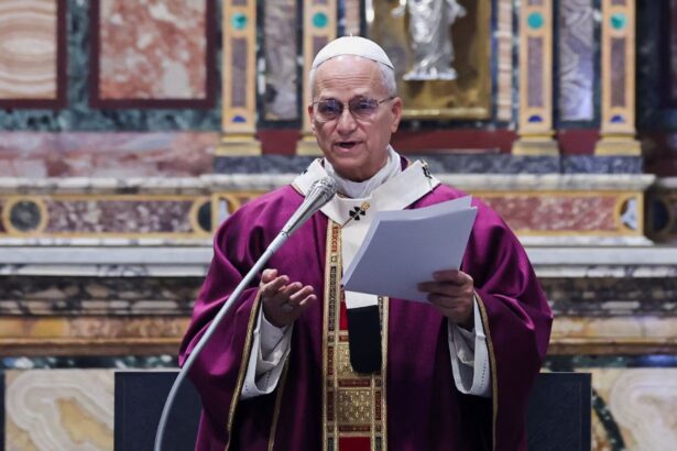 The current Pope speaking into a microphone to the people gathered at the church
