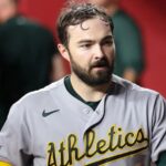 The star player walks into his team's dugout to prepare for his defensive inning