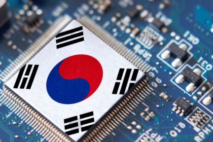 A small, high-tech microchip placed on a motherboard featuring the South Korean flag
