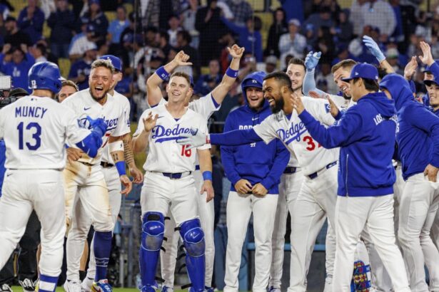 The Dodgers players waiting at home plate for one of their teammates after he scored the game-winning run