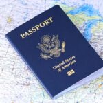 A United States passport placed on top of a world map