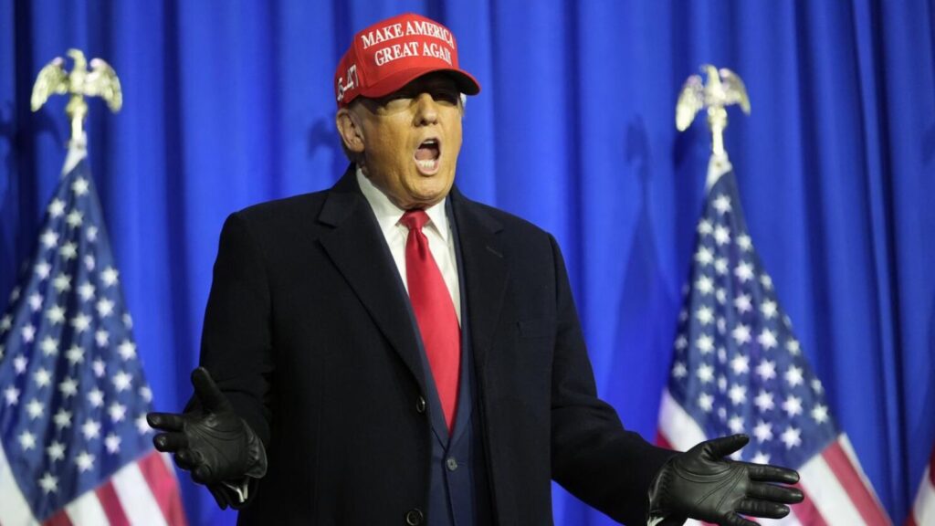 Donald Trump enthusiastically shouting while wearing a red cap bearing his name