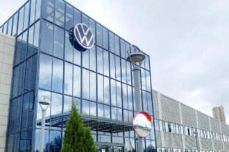 One of the automaker's office buildings featuring a large glass entrance and its iconic logo displayed above it