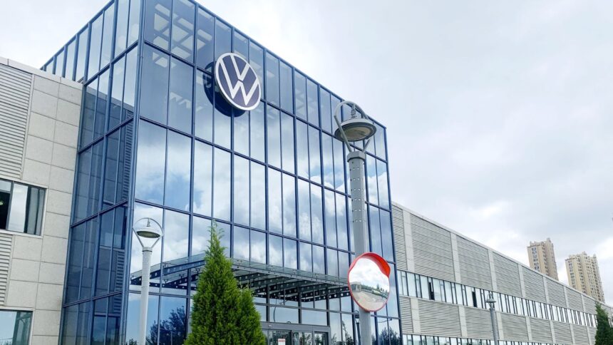 One of the automaker's office buildings featuring a large glass entrance and its iconic logo displayed above it