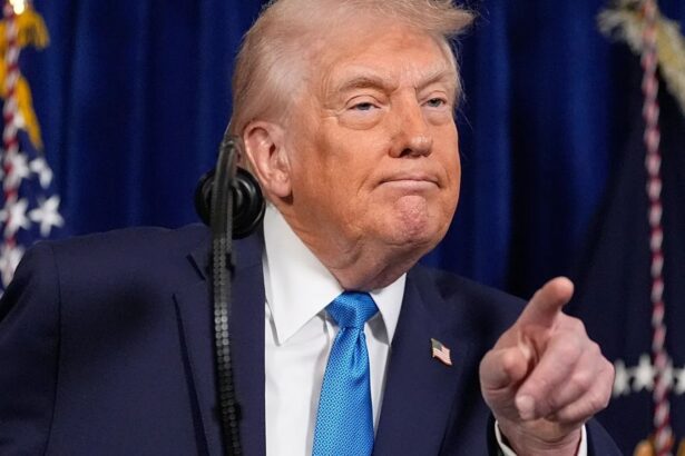 Donald Trump pointing with his finger while delivering a speech behind a podium