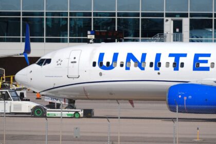 United Airlines revolutionizes air travel by saying goodbye to the uncomfortable middle seat An aircraft from the airline parked at an airport, featuring its iconic white livery and blue lettering