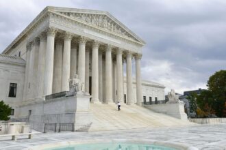 A panoramic view of the United States Supreme Court building, showcasing its massive walls and beautiful fountain