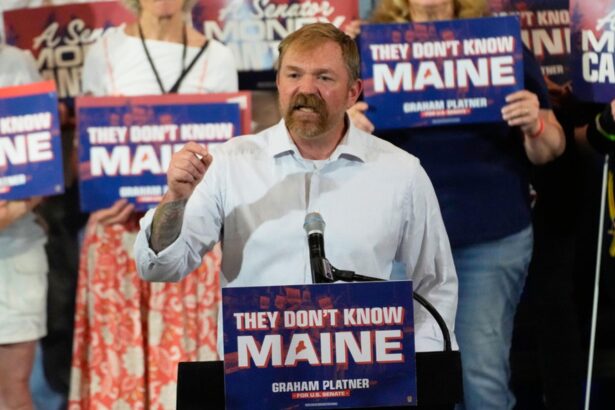 The Senate candidate standing at a podium, addressing a crowd of supporters during his campaign rally