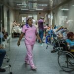 A hospital operating at full capacity, with numerous injured and sick patients following the disaster