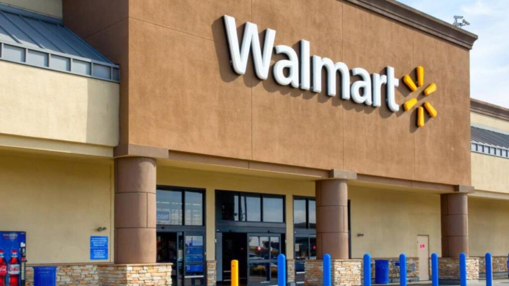 Walmart cuts prices as Trump claims his economic policies made It possible A photo of the exterior of a Walmart store featuring its iconic sign and a brick wall